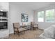 Relaxing sitting area with comfortable armchairs, a small table, and built-in shelving at 3934 Well Fleet Drive, Fuquay Varina, NC 27526