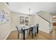 Cozy dining room with wood table, four comfortable gray chairs, and natural light at 418 Bergen Ave, Apex, NC 27502