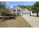 Charming two-story home with a well-manicured lawn and attached two-car garage on a sunny day at 418 Bergen Ave, Apex, NC 27502