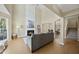 Bright living room with high ceilings, fireplace, gray sofa, and adjacent dining area at 418 Bergen Ave, Apex, NC 27502