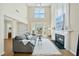 Bright living room with high ceilings, fireplace, and cozy gray sofa at 418 Bergen Ave, Apex, NC 27502
