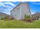 Spacious backyard with a well-kept lawn, two white Adirondack chairs, and lush landscaping at 4236 Aviemore, Burlington, NC 27215