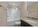 Bathroom featuring a granite vanity top, framed mirror, and a shower/tub combo with glass doors at 4236 Aviemore, Burlington, NC 27215