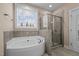 Bright bathroom with large soaking tub and separate glass shower at 4236 Aviemore, Burlington, NC 27215