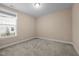 Bright bedroom featuring neutral walls and carpet, with natural light streaming through a large window at 4236 Aviemore, Burlington, NC 27215