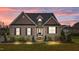 Inviting home exterior with illuminated landscape, brick facade, and cozy curb appeal at 4236 Aviemore, Burlington, NC 27215