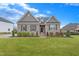 Inviting brick home featuring a lush green lawn, well-maintained shrubbery, and classic curb appeal at 4236 Aviemore, Burlington, NC 27215