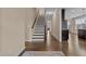 Hallway with hardwood floors, a staircase, and neutral wall colors, creating a warm and inviting atmosphere at 4236 Aviemore, Burlington, NC 27215