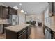 Open kitchen with dark cabinets, granite counters, stainless appliances, and view to the living room at 4236 Aviemore, Burlington, NC 27215