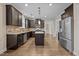 Well-appointed kitchen with dark wood cabinets, granite counters, stainless steel appliances, and hardwood flooring at 4236 Aviemore, Burlington, NC 27215