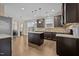 Modern kitchen with dark cabinetry, granite countertops, a kitchen island, and stainless steel appliances at 4236 Aviemore, Burlington, NC 27215
