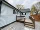 Backyard featuring deck, gray siding with black trim and rock landscaping at 1003 W Anderson St, Selma, NC 27576