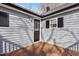 Backyard corner features a wood deck and gray siding with black trim at 1003 W Anderson St, Selma, NC 27576