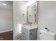 Bathroom featuring gray vanity with granite countertop, framed mirror, and modern fixtures at 1003 W Anderson St, Selma, NC 27576