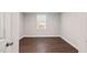 Bright bedroom with wood-look floors and a window with white blinds at 1003 W Anderson St, Selma, NC 27576