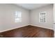 Bright bedroom with wood look floors and two windows providing lots of natural light at 1003 W Anderson St, Selma, NC 27576