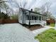 Charming home with new gravel driveway, a welcoming porch and neat landscaping around the front at 1003 W Anderson St, Selma, NC 27576