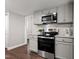 Modern kitchen with stainless steel appliances, granite countertops, and stylish gray cabinets at 1003 W Anderson St, Selma, NC 27576