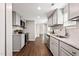 Updated kitchen with stainless appliances, granite counters, gray cabinets, and wood look floors at 1003 W Anderson St, Selma, NC 27576
