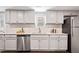 Bright kitchen with stainless steel appliances, granite countertops, and classic white cabinetry at 1003 W Anderson St, Selma, NC 27576