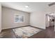 Bright living room with neutral walls, wood flooring, and a view of the kitchen for open living at 1003 W Anderson St, Selma, NC 27576