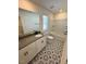 Bathroom featuring double vanity, granite counters, and decorative patterned flooring at 10548 Brookside Reserve Rd, Raleigh, NC 27614
