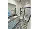 Bathroom featuring double vanity, granite counters, and decorative patterned flooring at 10548 Brookside Reserve Rd, Raleigh, NC 27614