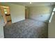 An open bedroom features neutral colored walls and gray carpeting at 10548 Brookside Reserve Rd, Raleigh, NC 27614