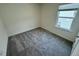 Cozy bedroom with neutral walls and carpet illuminated by a bright window at 10548 Brookside Reserve Rd, Raleigh, NC 27614