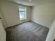 Bright bedroom with neutral walls and carpet illuminated by a window at 10548 Brookside Reserve Rd, Raleigh, NC 27614