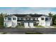 New construction townhomes with white and blue siding, black shutters, and attached garages at 10548 Brookside Reserve Rd, Raleigh, NC 27614