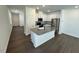 Open-concept kitchen featuring an island, stainless steel appliances, and white cabinets at 10548 Brookside Reserve Rd, Raleigh, NC 27614