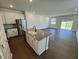 Open-concept kitchen featuring an island, stainless steel appliances, and white cabinets at 10548 Brookside Reserve Rd, Raleigh, NC 27614