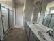 The bathroom has gray cabinets, double sinks, and a glass-enclosed shower at 165 Knoll Way, Sanford, NC 27332