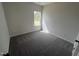 A light filled bedroom offers neutral walls, plush carpet and a large picture window at 165 Knoll Way, Sanford, NC 27332