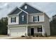 Charming two-story home with blue and grey siding and an attached two car garage at 165 Knoll Way, Sanford, NC 27332