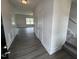 Bright foyer featuring wood-look floors, white wainscoting, and a staircase leading to the upper level at 165 Knoll Way, Sanford, NC 27332