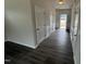 Inviting foyer with wood-look flooring, white wainscoting, and a view toward the front door at 165 Knoll Way, Sanford, NC 27332