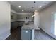 Kitchen showcasing grey cabinets, granite countertops, a spacious island, and recessed lighting at 165 Knoll Way, Sanford, NC 27332
