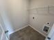 A practical laundry room featuring neutral walls, wire shelving, and tiled floors at 165 Knoll Way, Sanford, NC 27332