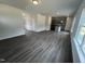 Open-concept living area with wood-look flooring connecting to the kitchen and dining spaces at 165 Knoll Way, Sanford, NC 27332