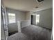 Carpeted loft area with natural light from the windows at 165 Knoll Way, Sanford, NC 27332