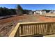 View of the large backyard from the deck; backyard is partially cleared with a wooded area in the distance at 200 Ironwood Lot 39 Blvd, Youngsville, NC 27596