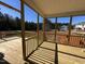Picture of a covered wooden deck overlooking a yard surrounded by a treeline at 200 Ironwood Lot 39 Blvd, Youngsville, NC 27596