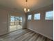 Bright dining room featuring a sliding glass door to deck, wood floors and contemporary light fixture at 200 Ironwood Lot 39 Blvd, Youngsville, NC 27596