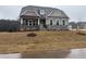 Charming home featuring stone accents, a covered porch, and a freshly installed lawn at 200 Ironwood Lot 39 Blvd, Youngsville, NC 27596