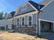 Exterior elevation of a two-story home with stone accents and gray siding at 200 Ironwood Lot 39 Blvd, Youngsville, NC 27596