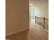 Hallway featuring carpet flooring, base trim and railing along the stairs at 200 Ironwood Lot 39 Blvd, Youngsville, NC 27596