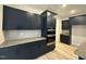 Modern kitchen featuring navy cabinets, stainless steel appliances, and stone countertops at 200 Ironwood Lot 39 Blvd, Youngsville, NC 27596