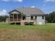Lovely home exterior with a spacious backyard, deck, screened-in porch, and beautiful lawn at 200 Ironwood Lot 39 Blvd, Youngsville, NC 27596